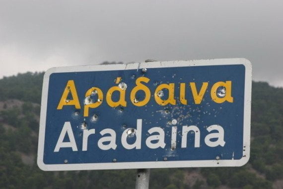 Aradaina road sign with bullet holes