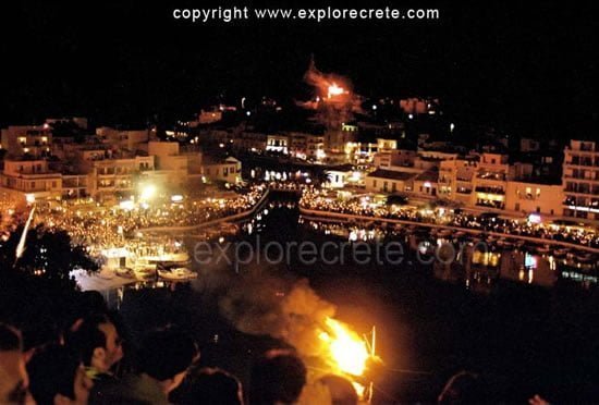 People celebrating the Resurrection of Christ by the lake of Agios Nikolaos