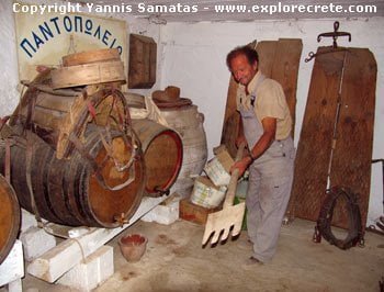 in the cellar of Manolis Piperakis who shows the procedure of separating the wheat from the chaff in the alonia