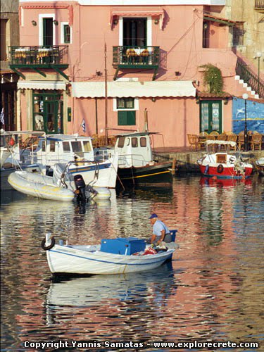 fishing boat mirroring in the waters of the Venetian harbour of Rethymnon